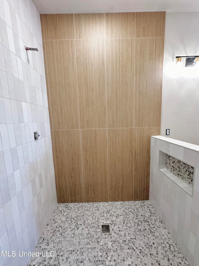 bathroom with tiled shower