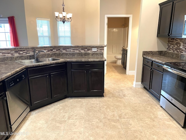 kitchen with sink, a chandelier, decorative backsplash, hanging light fixtures, and stainless steel appliances