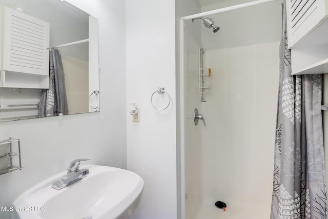 603 James Ave, Wiggins, MS 39577 - bathroom with a sink and curtained shower