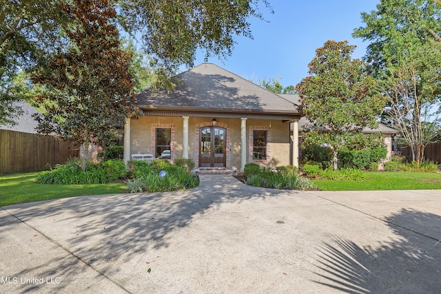 view of front of home featuring stucco siding, french doors, a porch, and fence