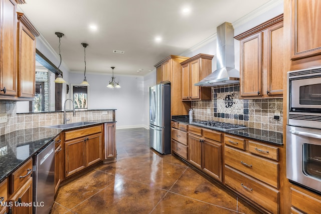 kitchen featuring hanging light fixtures, appliances with stainless steel finishes, crown molding, wall chimney exhaust hood, and sink