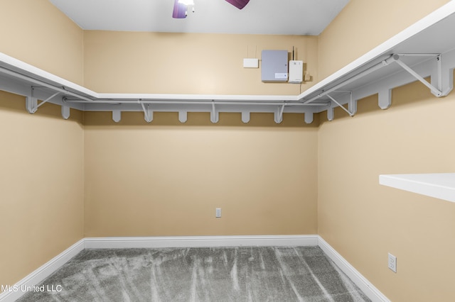 walk in closet with carpet flooring and ceiling fan