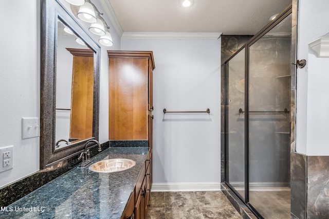 full bathroom with baseboards, vanity, a shower stall, and ornamental molding