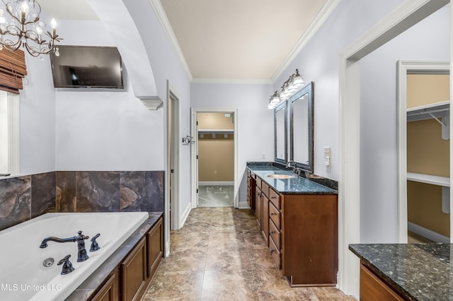 bathroom featuring an inviting chandelier, vanity, ornamental molding, a walk in closet, and a bath