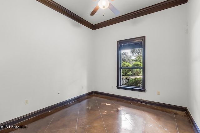 empty room featuring ornamental molding, dark tile patterned floors, and ceiling fan