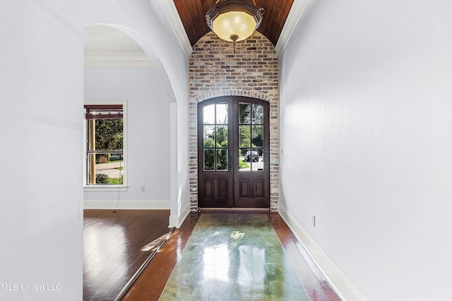 foyer featuring ornamental molding, dark wood-type flooring, vaulted ceiling, and wood ceiling