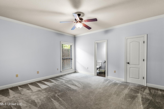 unfurnished bedroom featuring carpet, ornamental molding, baseboards, ceiling fan, and ensuite bathroom