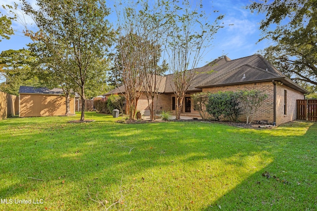 exterior space featuring a storage shed and a lawn