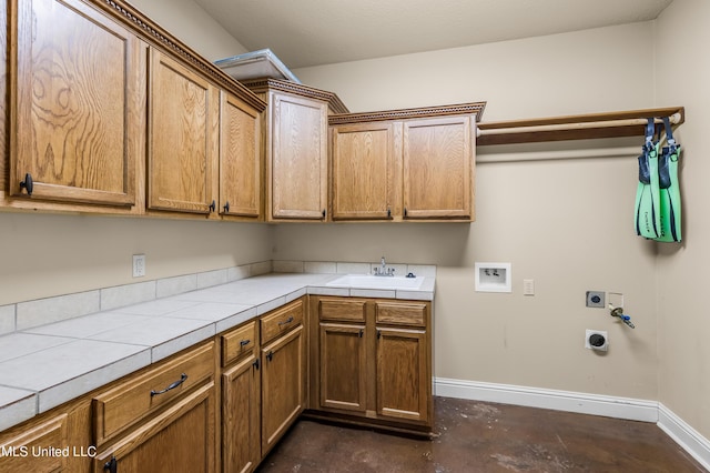 clothes washing area with a sink, hookup for a washing machine, hookup for an electric dryer, cabinet space, and baseboards