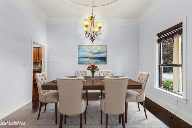 dining area featuring a chandelier, wood finished floors, baseboards, and ornamental molding