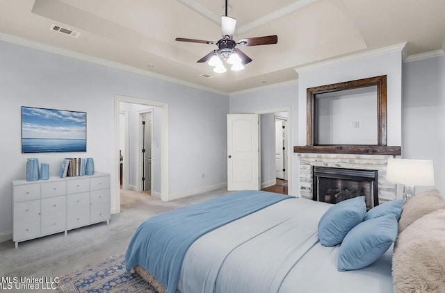 bedroom featuring a stone fireplace, visible vents, ornamental molding, baseboards, and light colored carpet