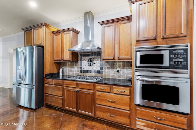 kitchen with backsplash, ornamental molding, wall chimney exhaust hood, brown cabinetry, and appliances with stainless steel finishes