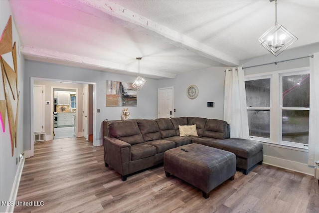 living room with beamed ceiling and wood-type flooring