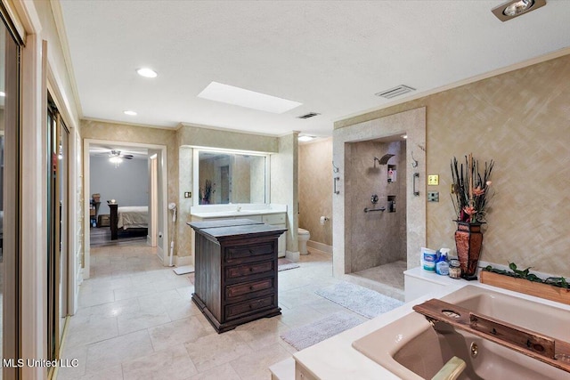 full bathroom featuring a skylight, separate shower and tub, toilet, vanity, and crown molding