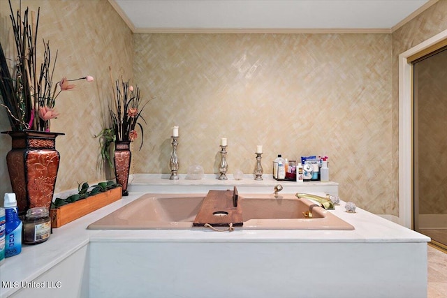 bathroom with ornamental molding and a bathing tub