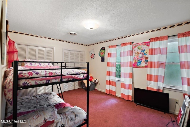 carpeted bedroom featuring a textured ceiling