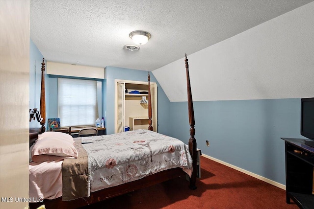 carpeted bedroom featuring lofted ceiling and a textured ceiling