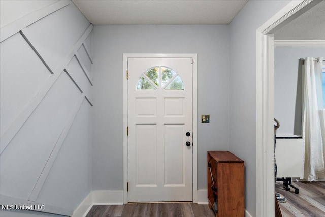 entrance foyer featuring a textured ceiling and hardwood / wood-style floors