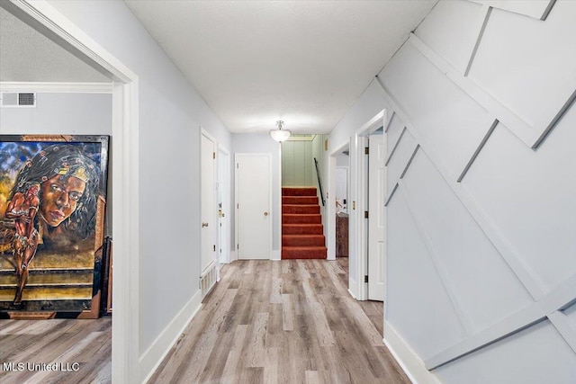 hall with light hardwood / wood-style flooring