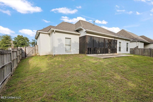 104 Glenwild Trl, Canton, MS 39046 - back of property with a patio area, a fenced backyard, a gate, a shingled roof, and a sunroom