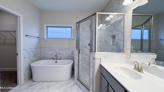 bathroom with vanity, tile walls, and independent shower and bath