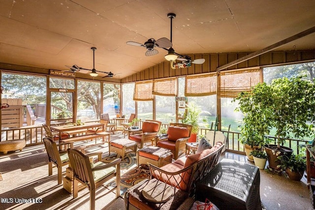 sunroom with ceiling fan and lofted ceiling