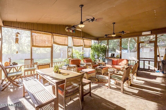 sunroom with ceiling fan, a wealth of natural light, and vaulted ceiling