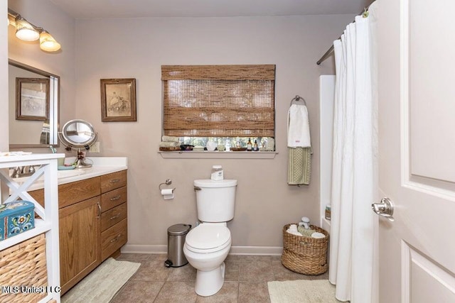 bathroom featuring tile patterned flooring, vanity, and toilet