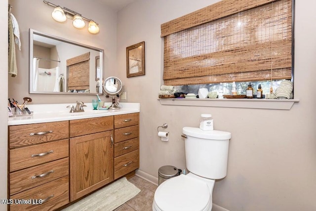 bathroom with tile patterned floors, a shower, vanity, and toilet