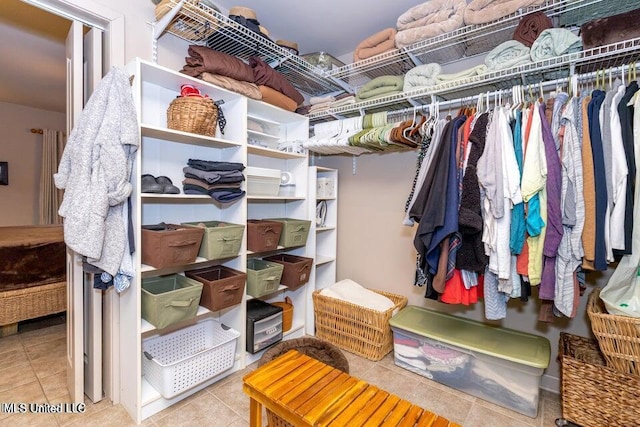 walk in closet featuring light tile patterned flooring