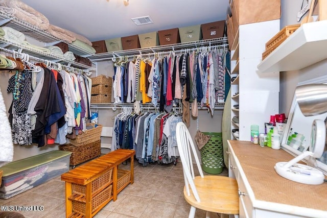 walk in closet with light tile patterned flooring