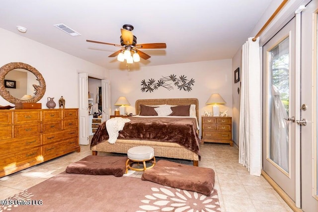 tiled bedroom featuring ceiling fan