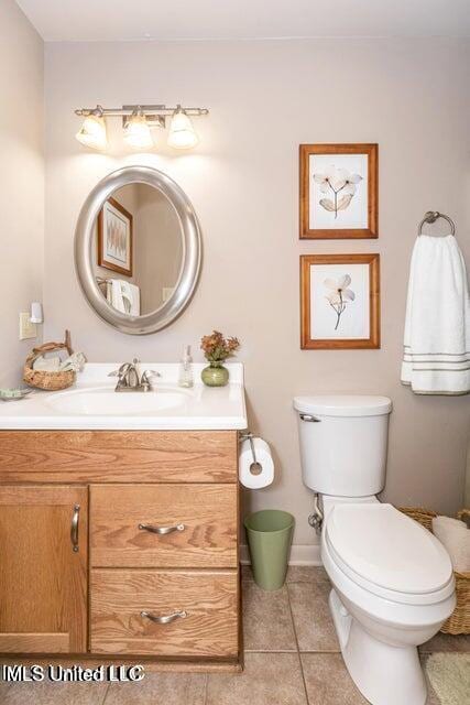 bathroom with tile patterned floors, vanity, and toilet