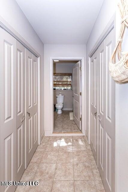 hall featuring light tile patterned floors