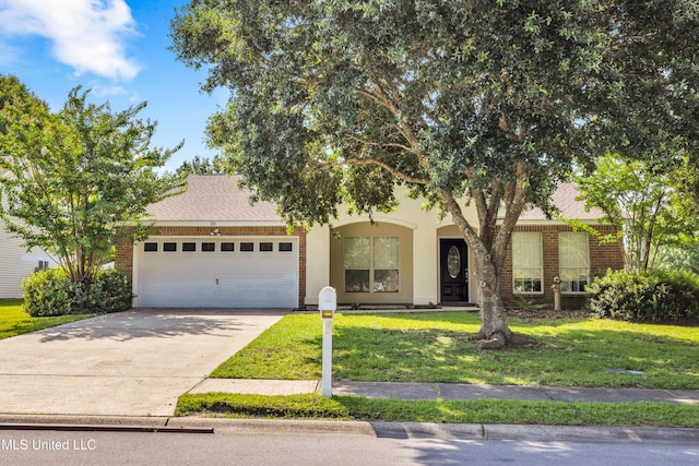 20 Lakeview Dr, Ocean Springs, MS 39564 - obstructed view of property with a garage, a front yard, concrete driveway, and brick siding