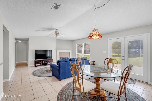 20 Lakeview Dr, Ocean Springs, MS 39564 - dining area with light tile patterned floors, french doors, a ceiling fan, a textured ceiling, and vaulted ceiling
