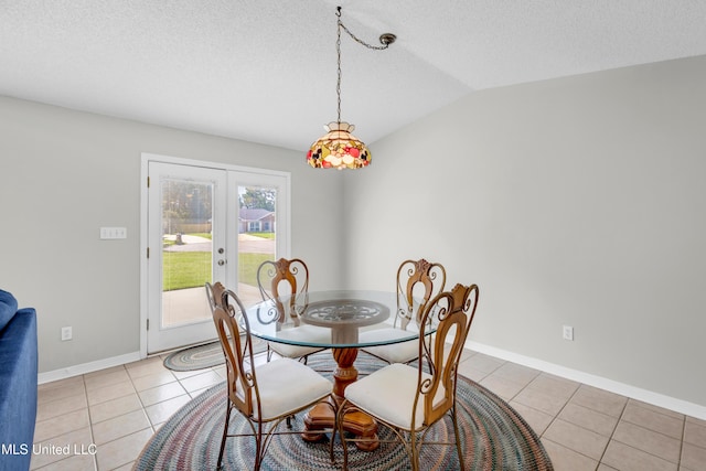 20 Lakeview Dr, Ocean Springs, MS 39564 - dining area with french doors, light tile patterned floors, lofted ceiling, and a textured ceiling
