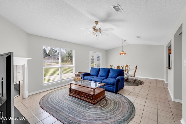 20 Lakeview Dr, Ocean Springs, MS 39564 - living area featuring light tile patterned flooring, a ceiling fan, vaulted ceiling, and a textured ceiling