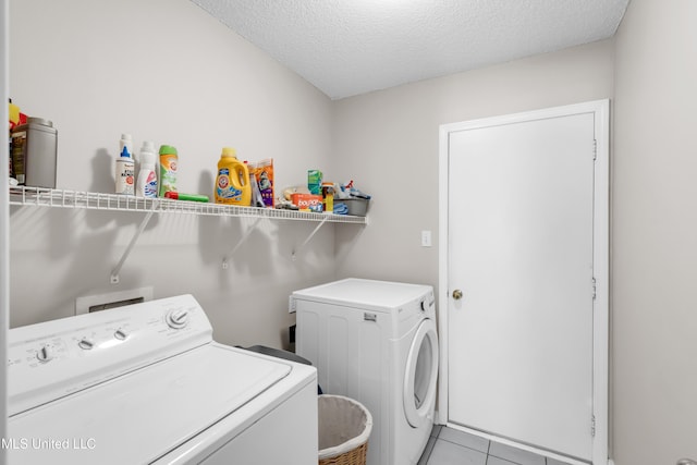 20 Lakeview Dr, Ocean Springs, MS 39564 - laundry room with washing machine and dryer, a textured ceiling, and light tile patterned floors