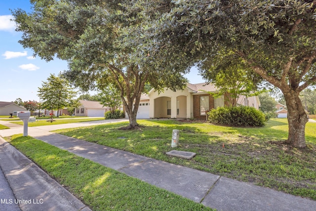 20 Lakeview Dr, Ocean Springs, MS 39564 - obstructed view of property featuring concrete driveway, a garage, and a front yard
