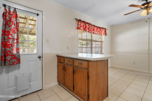 kitchen with light tile patterned flooring, ceiling fan, and kitchen peninsula