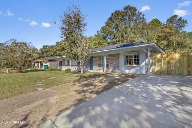 ranch-style house with a carport and a front lawn