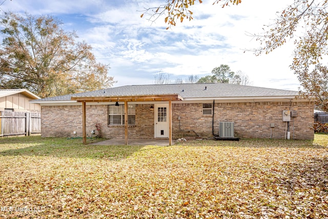 rear view of house with a yard, central AC, and a patio