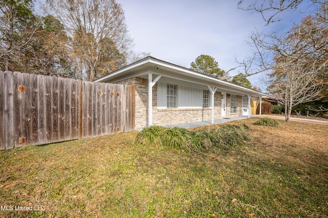 view of side of property with a yard