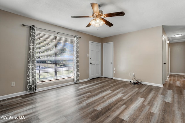 unfurnished room featuring ceiling fan, hardwood / wood-style floors, and a textured ceiling