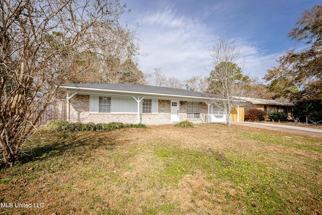 ranch-style home featuring a carport and a front yard