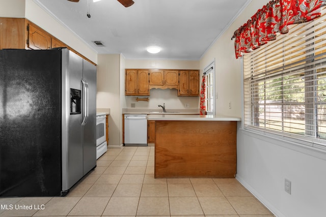 kitchen with sink, crown molding, light tile patterned floors, kitchen peninsula, and white appliances