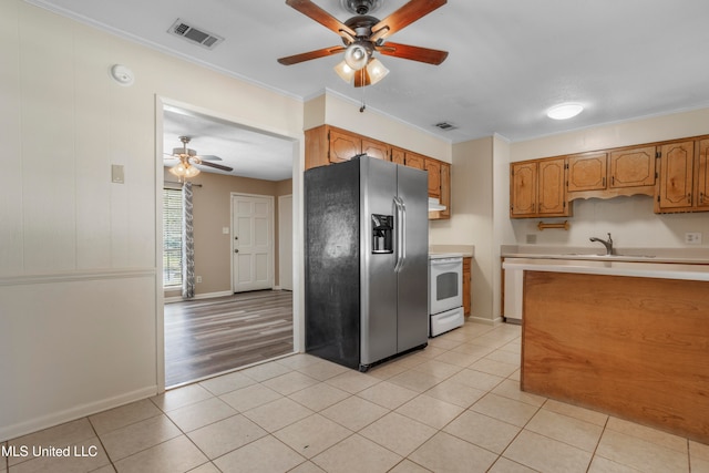 kitchen with light tile patterned flooring, white electric stove, sink, ornamental molding, and stainless steel fridge with ice dispenser