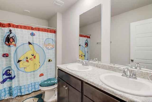 bathroom featuring toilet, vanity, tile patterned flooring, and a shower with shower curtain