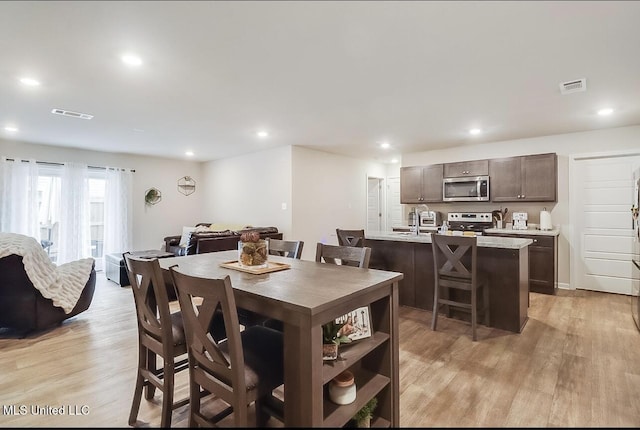 dining area featuring light wood-type flooring